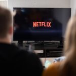 With media in upheaval, Netflix stays out of the fray